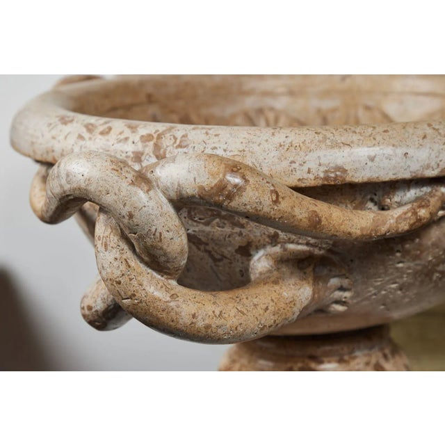 A dramatic, grand-scale, solid marble, sculpted Italian tazza with three sets of intertwined, serpentine arms surrounding...