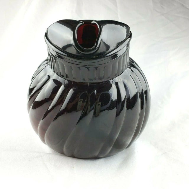 Anchor Hocking Royal Ruby Swirl Tilted Ball Pitcher Measures 8.50 in x 4 in diameter base, 5 in diameter top