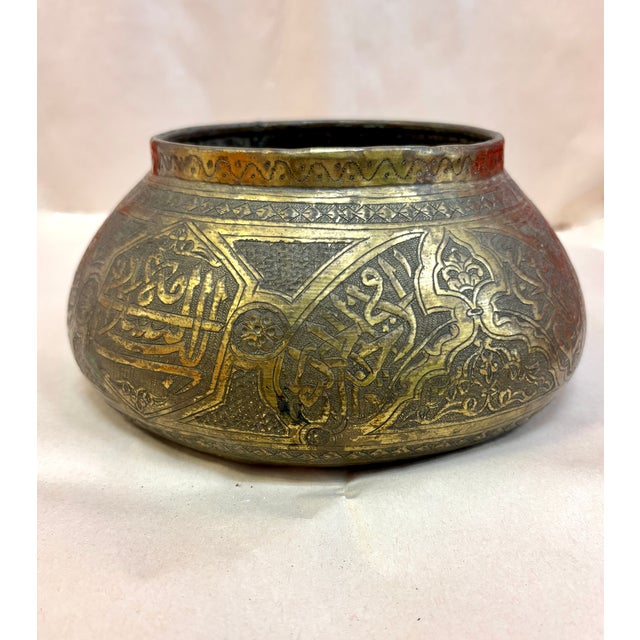 An evocative antique Syrian Damascus brass bowl, circa 1890–1915, crafted in the Mamluk Revival tradition that flourished...