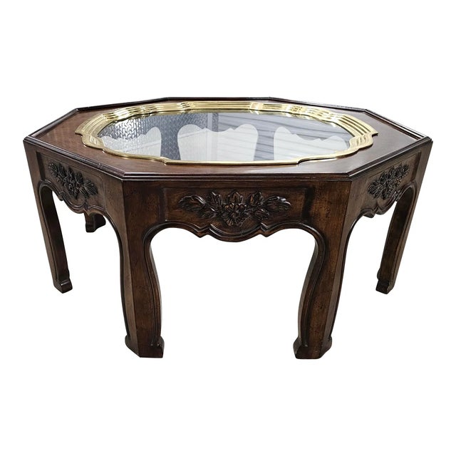Featured is an organic Hollywood Regency Vintage Octagonal Ethnographic Wood, Brass & Glass Cocktail Table. It resembles a...