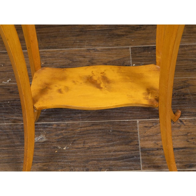 An Austrian Biedermeier period end table from the mid 19th century, with octagonal top, darker accentuation, partitioned...