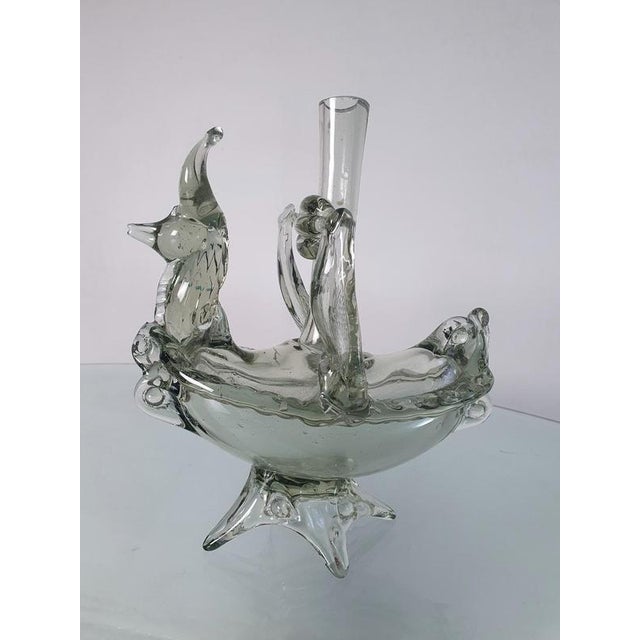 A unique Murano glass vessel that can be used as a vase, bottle or a candle holder in the shape of some kind of mystical...
