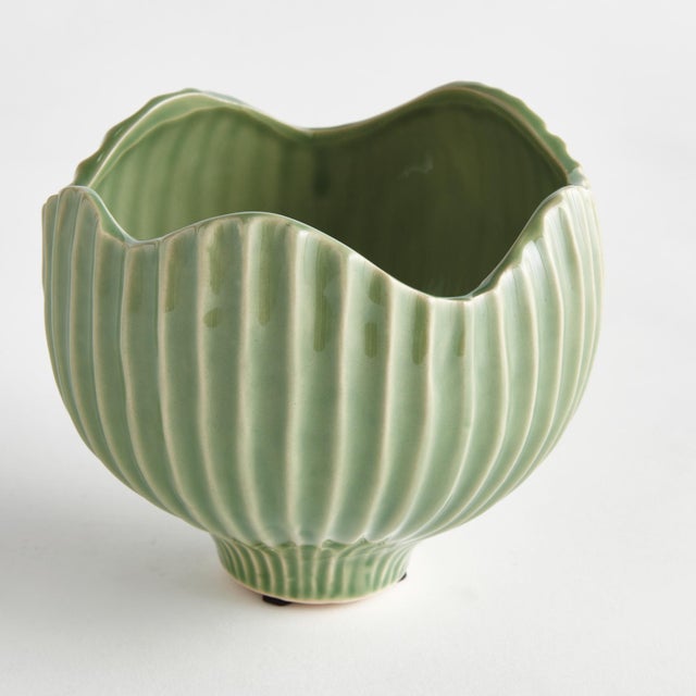 With a ribbed texture and wavy rim, this ceramic pot certainly brings the charm. Finished in a rich, reactive glaze, it...