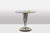 Organ-shaped pedestal table, in chrome metal and matte golden brass, with its smoked glass top. Work realized in the...