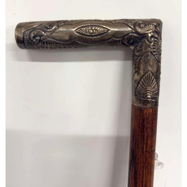 Antique cane, marked "Sterling" on the handle, wood shaft, brass-tone ferrule; No maker mark observed; Measures...