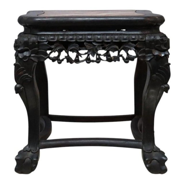 An exquisite antique Chinese side table, crafted from richly carved rosewood and featuring a striking rouge marble top,...