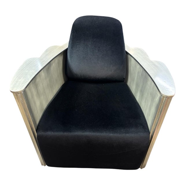 This is a pair of antique Art Deco club chairs featuring a silver leaf design over wood construction and black velvet...