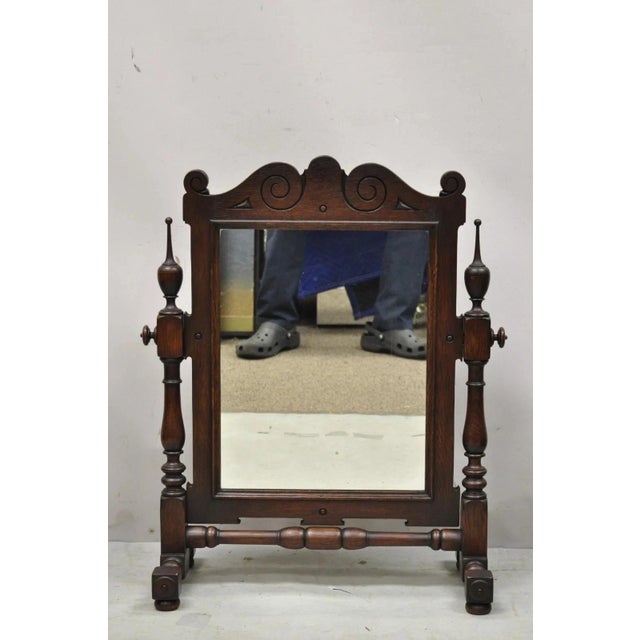 Antique Jacobean Style Oak Wood Pivoting Table Top Dresser Shaving Mirror. Item features carved wood finials, pivoting...