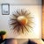 A large vintage gold-toned sunburst wall/ceiling light, broadly dating to the 1950s–1960s. Alternating slender rods and...