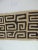 Vintage natural and black African applique Kuba textile with orange raphia stitches. Size: 20" W x 95" L.