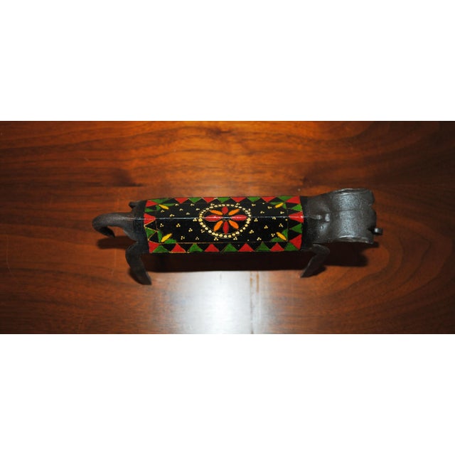 This brutalist inspired elephant is forged from a piece of angle iron. It has a brightly painted design on the back. Nice...