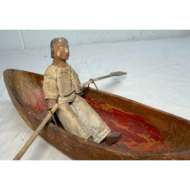 Up for sale is an exquisite antique hand carved wooden Canadian Inuit wooden sculpture depicting a canoeing man. This...