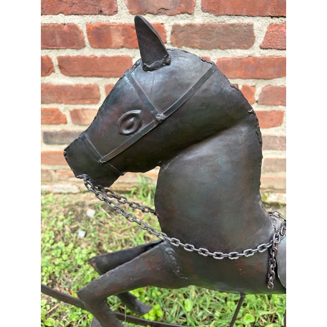 Large, charming vintage handcrafted hammered metal galloping rocking horse sculpture. A dark, distressed black finish,...