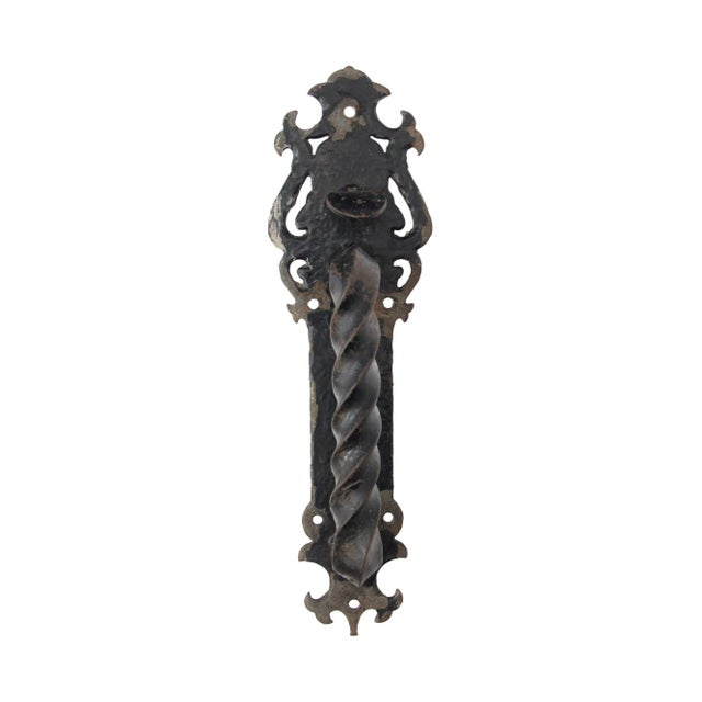 Black hand forged Arts & Crafts cast iron door pull with a twisted handle and thumb latch. It is in excellent condition....
