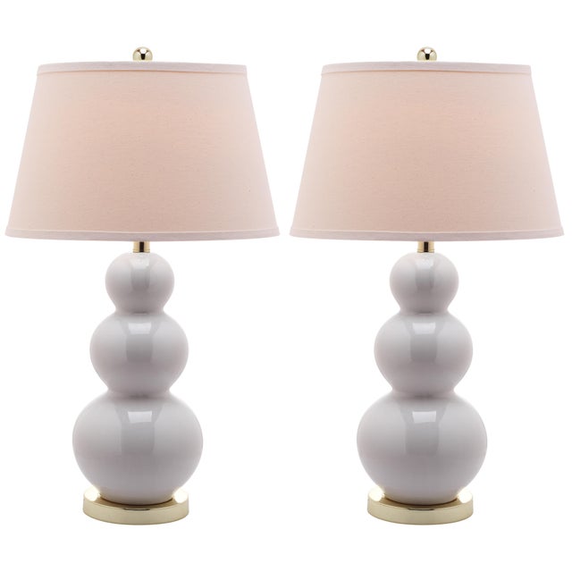 Balance fashion, form and function with the Triple Gourd table lamp, it's three beautifully turned white ceramic gourds...