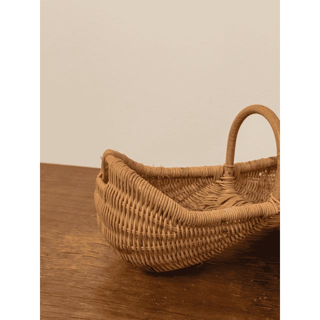 Handwoven French wicker basket with two compartments and a central carrying handle in an elegant hourglass form. Perfect...