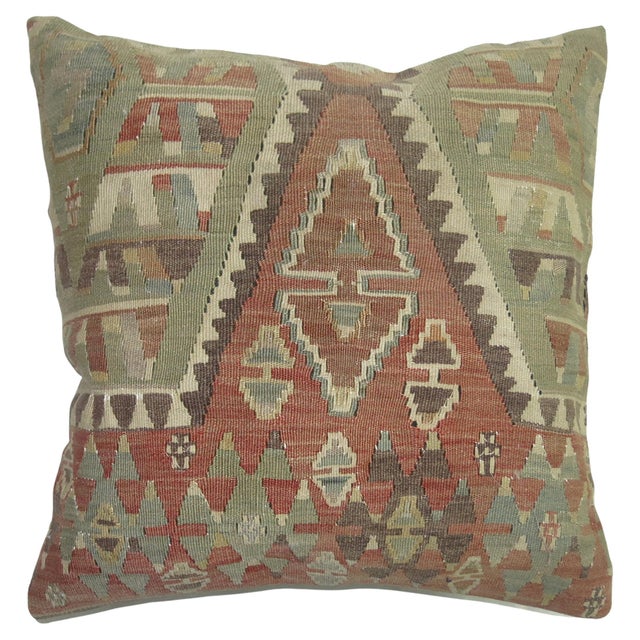 Pillow made from an early 20th century Turkish Kilim. Polyfill insert provided with a zipper closure Measures: 19'' x 19''.