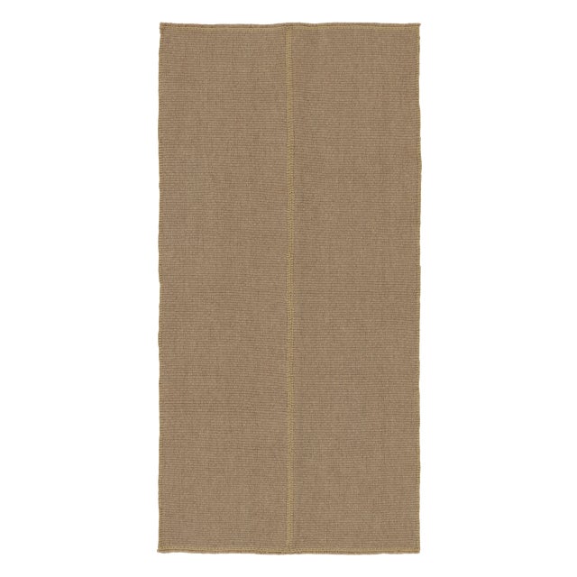 Handwoven in wool, this 4x7 Rez Kilim showcases a softly textured taupe field accented by a subtle tonal stripe running...