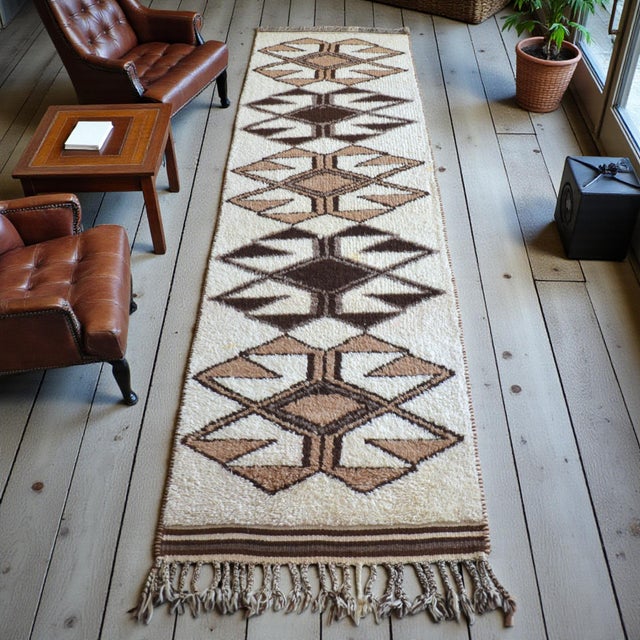 This authentic Kurdish runner rug, dating back to the 1970s, is a striking example of tribal weaving from Southeastern...