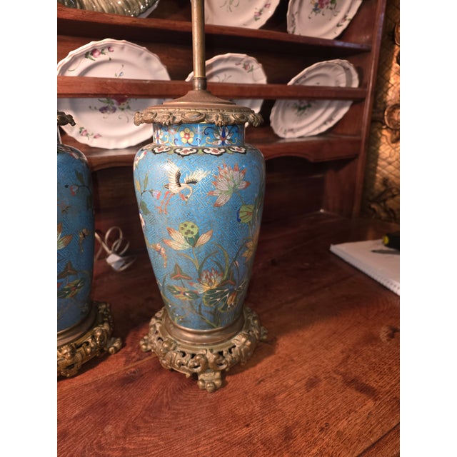 Beautiful antique Chinese Cloisonne enamel lamps with ornate metal bases.