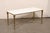 A French brass coffee table, with marble top, from the mid 20th century. This mid-century coffee table from France...