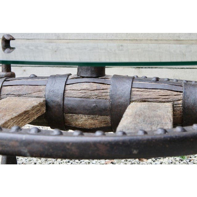 This unique table is extremely rare. It is an antique spanish cart wheel, once used on a horse drawn cart in europe,...