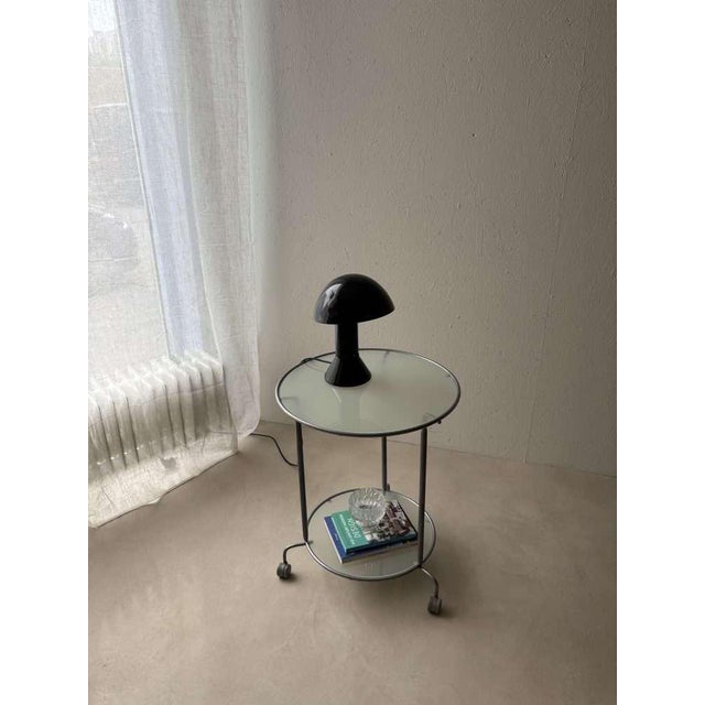 The unique space age table lamp "elmetto," designed in 1976 by italian designer elio martinelli and produced by martinelli...