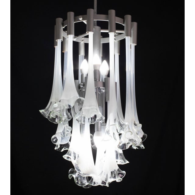 Extraordinary and rare orange-colored Murano glass Calle chandelier attributable to Venini. Design period: 1970. The frame...