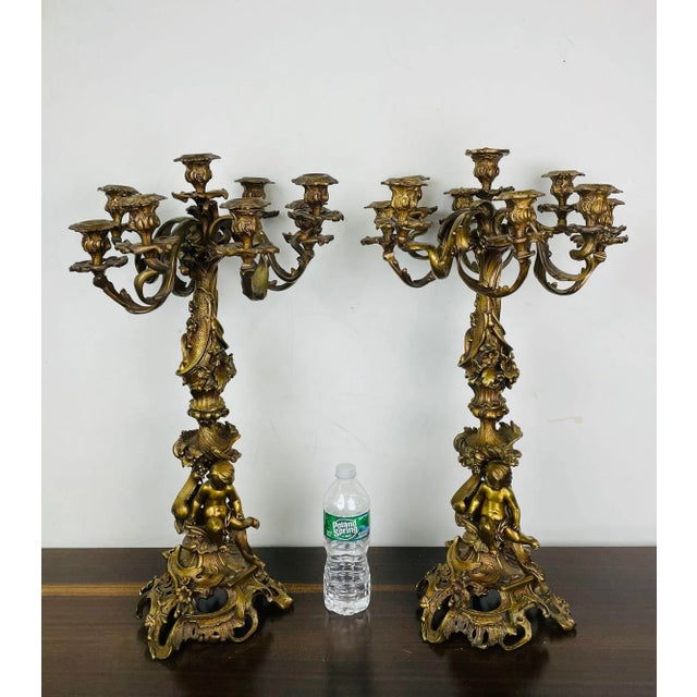 Pair of Louis XVI Style Gilt Bronze Candelabra, Cherub Florentine Form A large and impressive pair of Candelabra, each...
