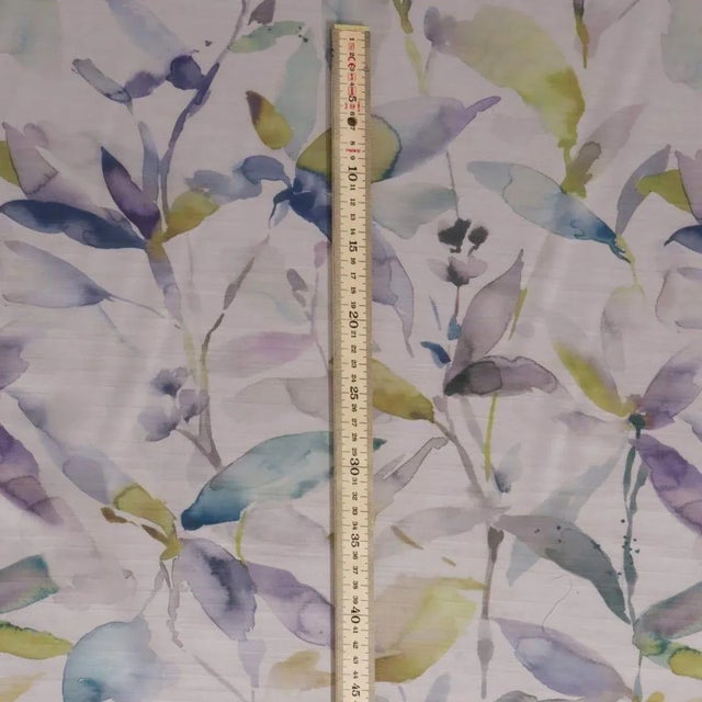 Printed on a beautiful satin base cloth, long stems and leaves form a modern pattern in subtly bright colours with a cool...