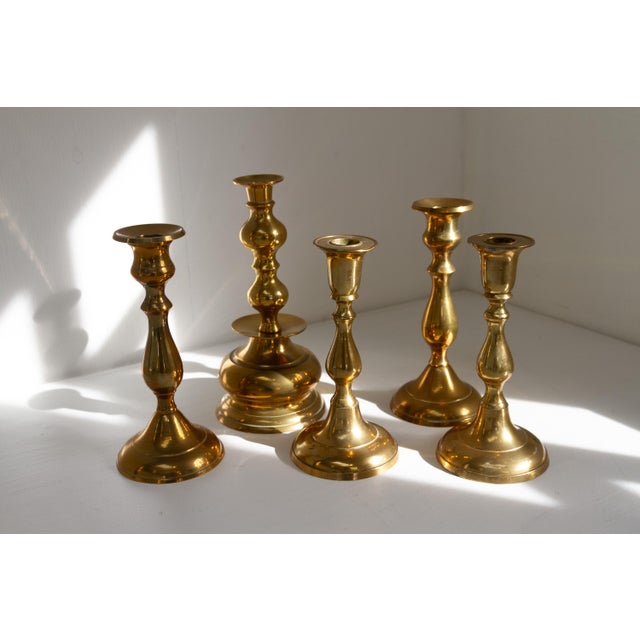 Set of five candle holders in solid brass from Denmark circa 1930-1960. This set consists of two pair and a single bell...