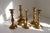 Set of five candle holders in solid brass from Denmark circa 1930-1960. This set consists of two pair and a single bell...