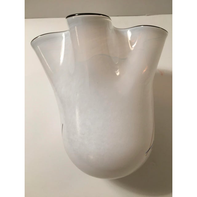 This art glass vase is signed on the ground glass base. The top edge is in black The design is floating lines in multi...