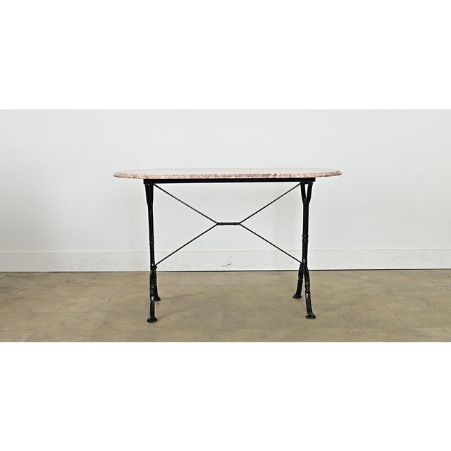 An exceptional late 19th century French dining table from a bistro, with fabulous design elements throughout. The pink...