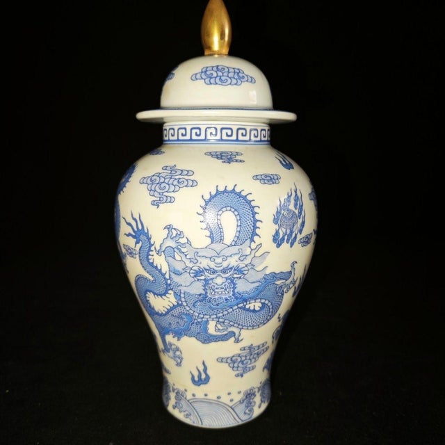 Elegant Chinese blue and white porcelain general jar topped with a polished gilded finial on the domed lid. The creamy...