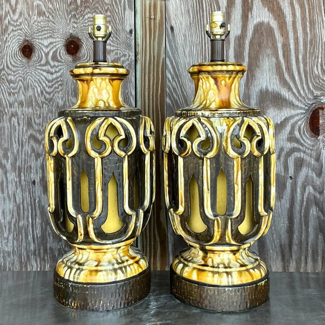 Add a touch of classic American style to your home with this pair of Vintage MCM Glazed Ceramic Lamps. Exemplifying the...