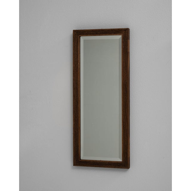 This pair of early 1900s French mirrors is framed in dark wood with clean, understated lines. Beveled plates add subtle...