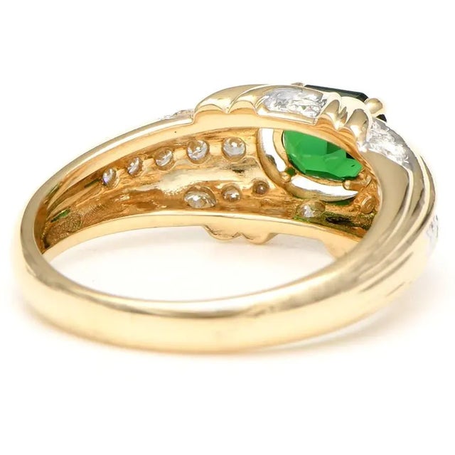 This elegant ring features an emerald cut Tsavorite garnet of stunning intensity. It's set in a yellow gold band and...