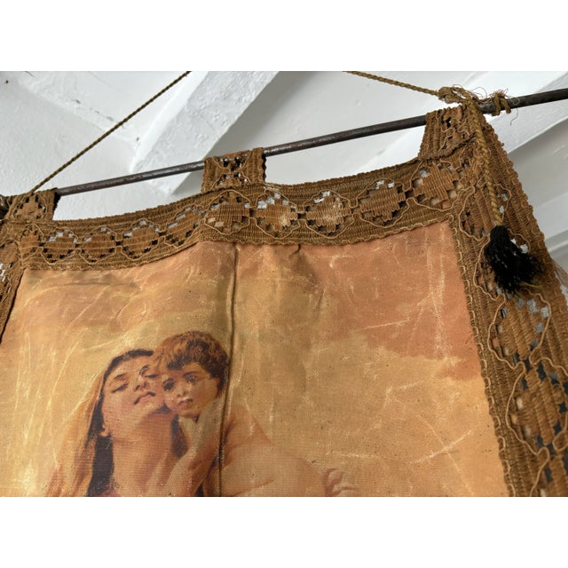 Beautiful oleograph of Mary and Jesus. Original tassels and bar on top and bottom to keep a good weight for hanging. One...