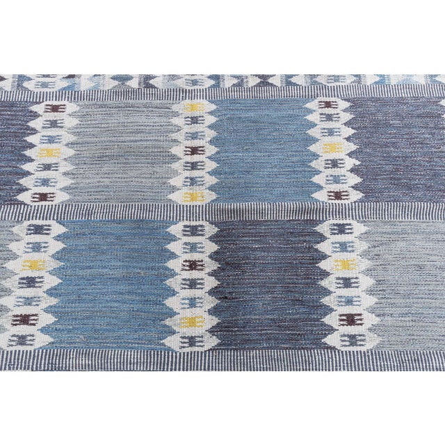 This modern Swedish flat-weave rug presents a beautifully balanced geometric composition defined by vertical bands and...