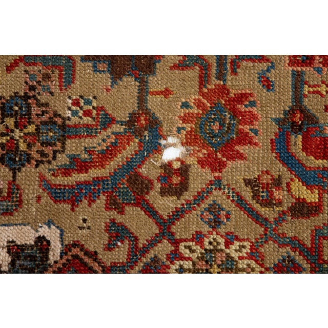 Beautiful antique Bakshaish hand-knotted wool rug with a brown color field. This piece has a blue frame and red accents on...