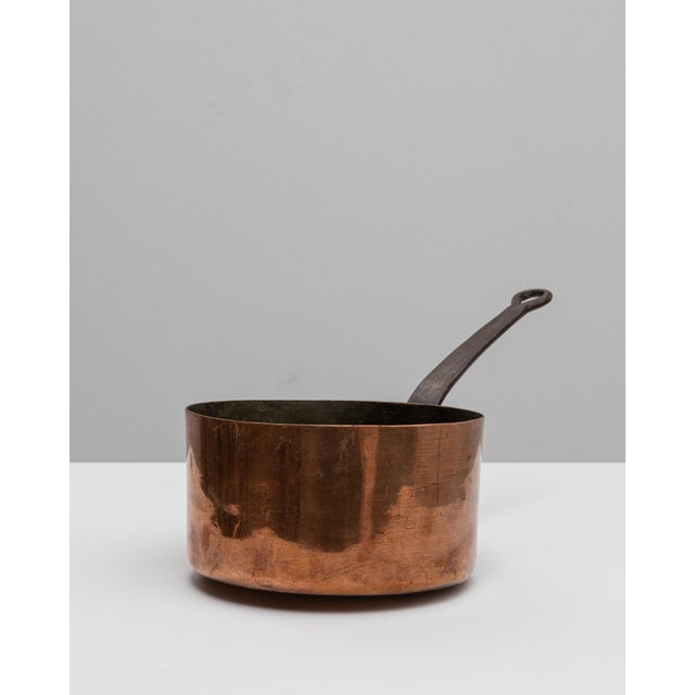 This 19th-century French copper pot is a fine example of traditional cookware from the era, blending beauty with utility....