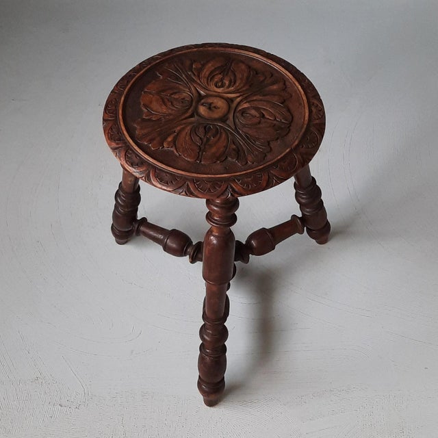 Antique, likely French, wooden stool with carved seat. In beautiful condition.