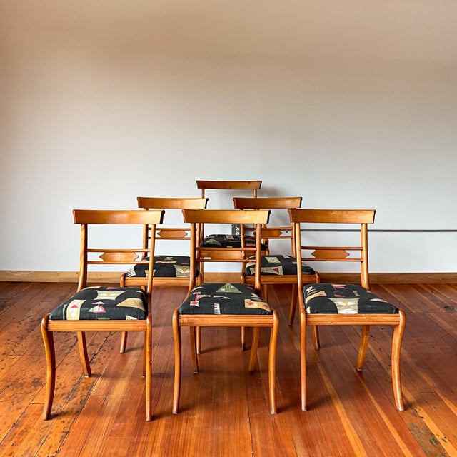 Set of 6 beautiful curved wood chairs. 5 without arms 1 with arms. Elegant open back and fun patterned fabric.