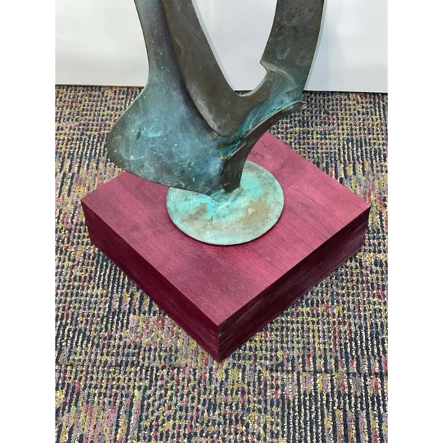 Beautiful vintage abstract bronze with great patina. Newly mounted on a purple heart base. Not signed that we can find....