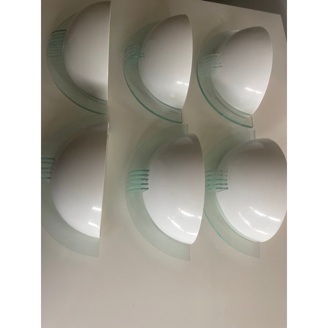 Set of 6 vintage wall sconces /lamps. 1980s. White metal half moon with acrylic or plexiglass back plate and...