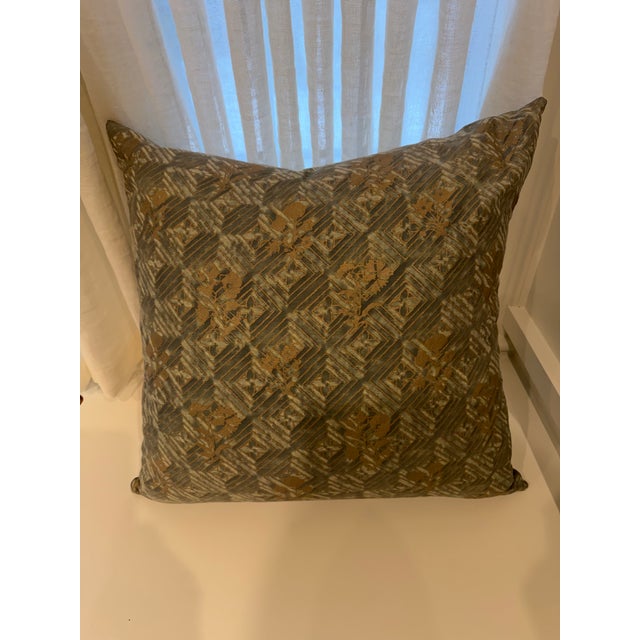 Decorative pillow in Fortuny muted blue and gold metallic fabric.
