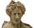 A 19th century carved stone bust. The handsome figure in Greco-Roman attire with toga draped over the shoulder and a...