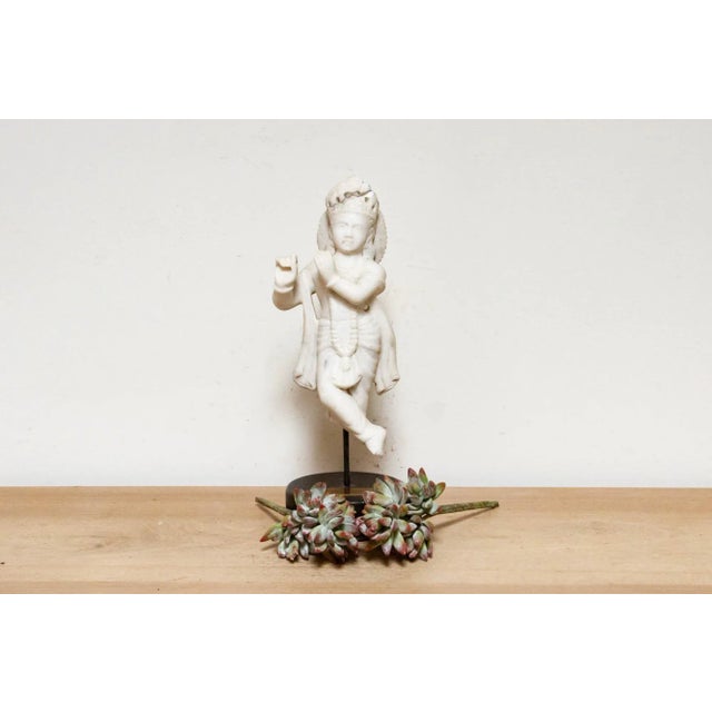 This exquisite 19th-century carved white marble sculpture depicts Krishna, a deity in Hinduism. Known as an incarnation of...