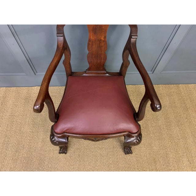 An imposing walnut high back armchair in the queen Anne style. Well constructed in solid walnut, the frame is strong and...